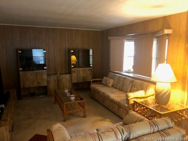 21 Los Lagos Road Port St. Lucie, FL 34952 - Photo 4 of 25 a living room with furniture and a lamp