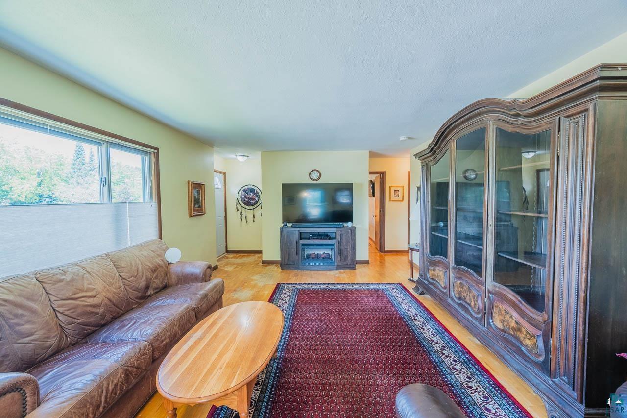 101 2nd Avenue North Biwabik, MN 55708 - Photo 2 of 44 Spacious room featuring wood-finish flooring and multiple windows providing natural light