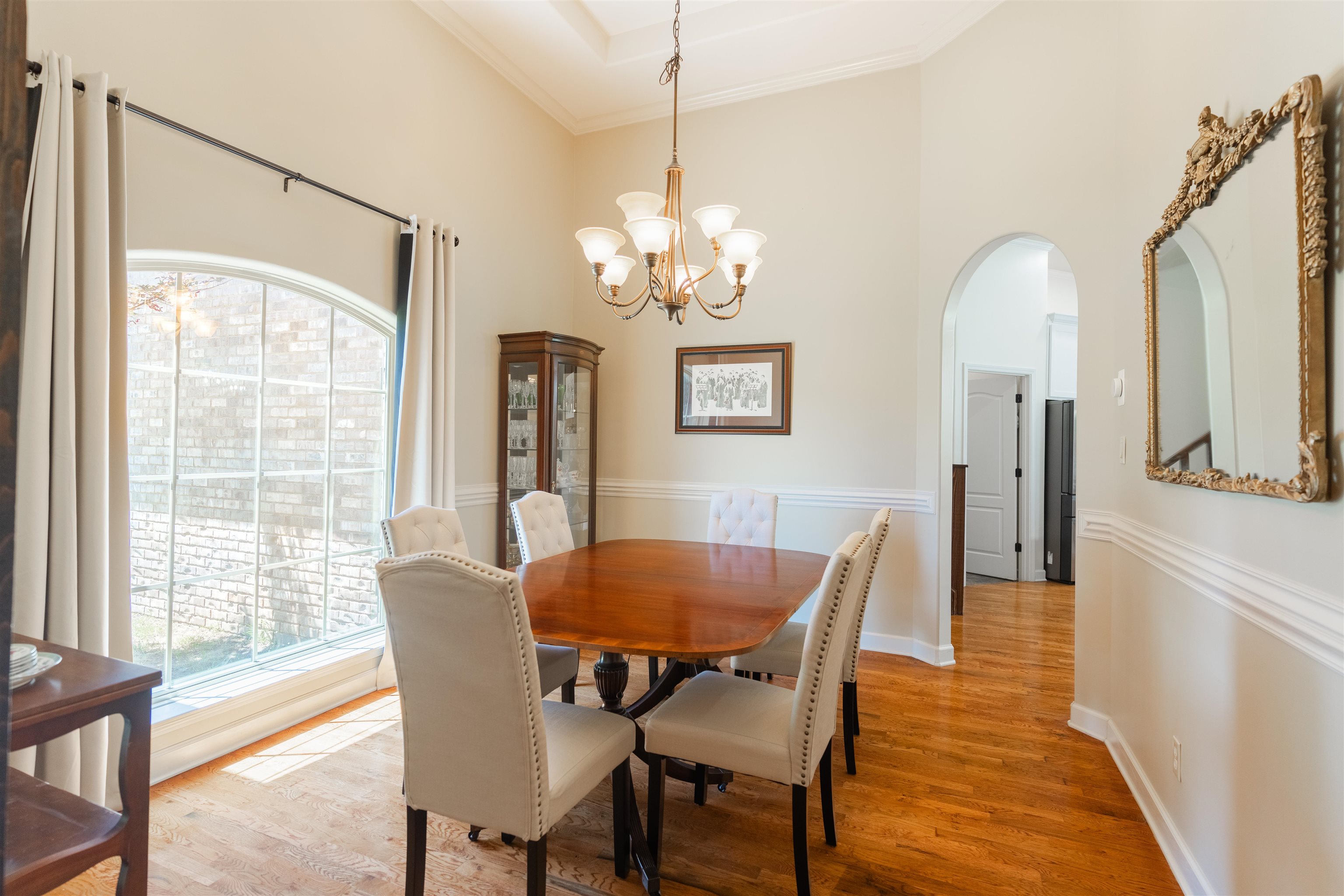 85 Casey Jordan Road Oakland, TN 38060 - Photo 6 of 36 Dining space with a notable chandelier, hardwood / wood-style flooring, a towering ceiling, and a wealth of natural light