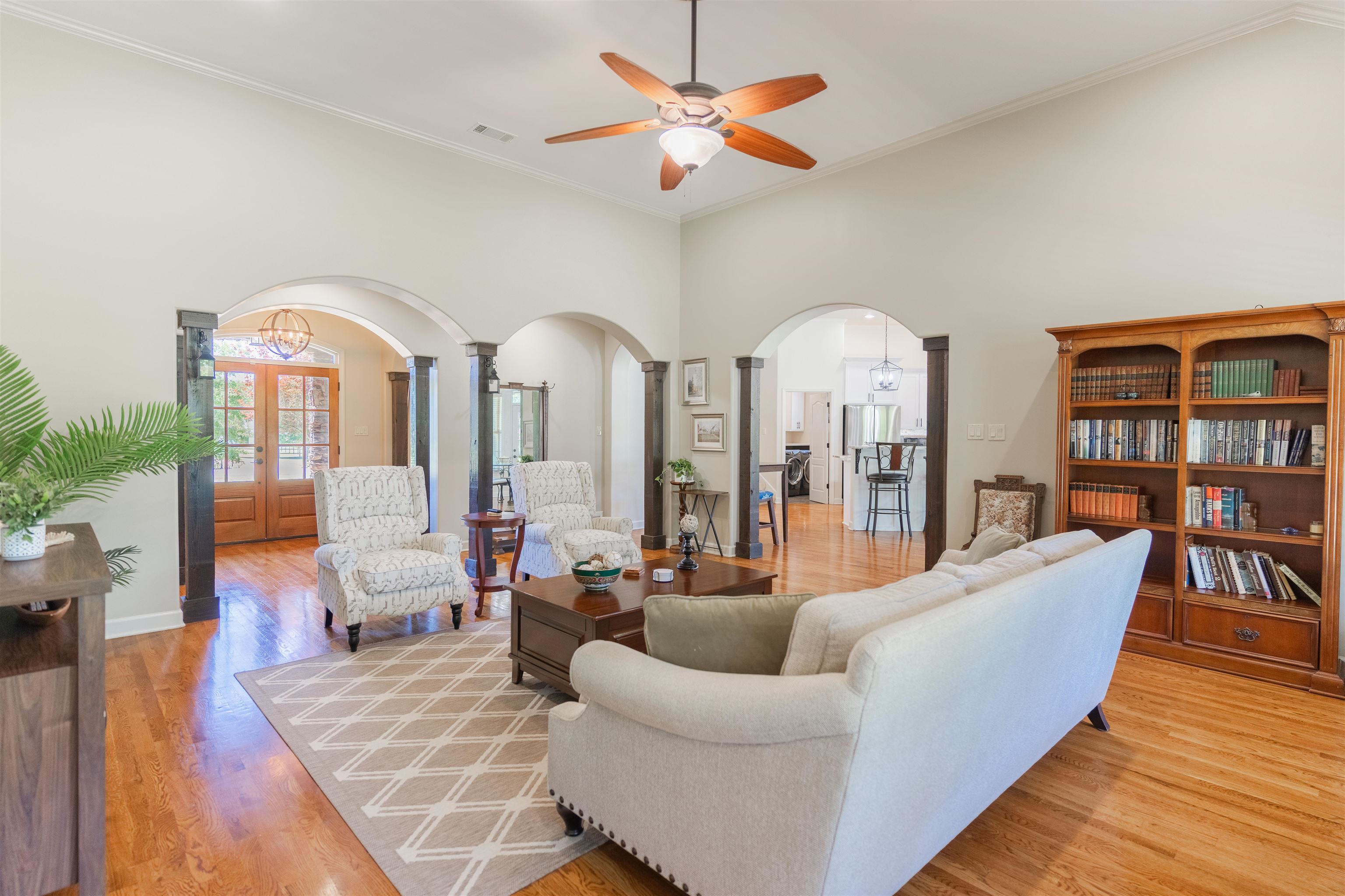 85 Casey Jordan Road Oakland, TN 38060 - Photo 9 of 36 Living room with light hardwood / wood-style flooring, ceiling fan, ornamental molding, a high ceiling, and french doors