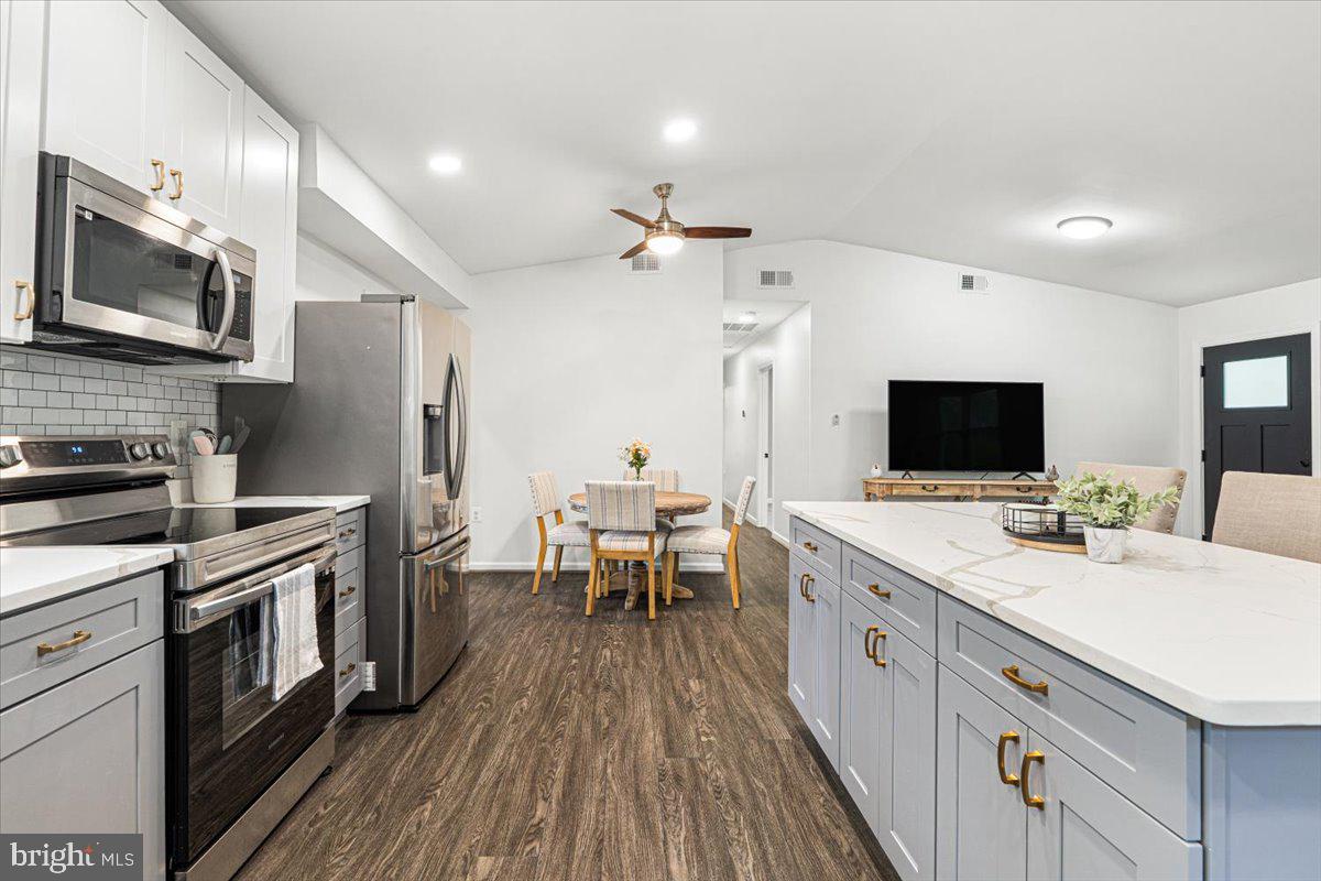 2816 Ballenger Creek Pike Frederick, MD 21703 - Photo 12 of 38 a large kitchen with a stove and a sink