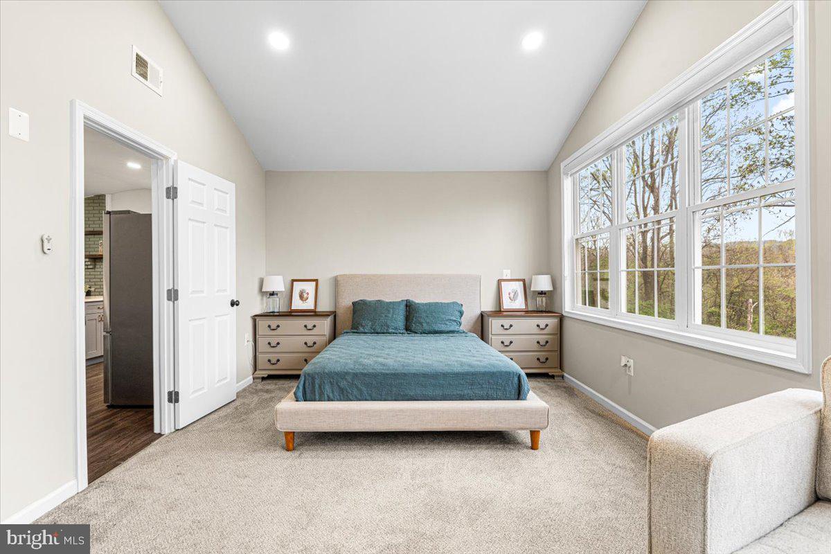 2816 Ballenger Creek Pike Frederick, MD 21703 - Photo 14 of 38 a spacious bedroom with a bed and a large window