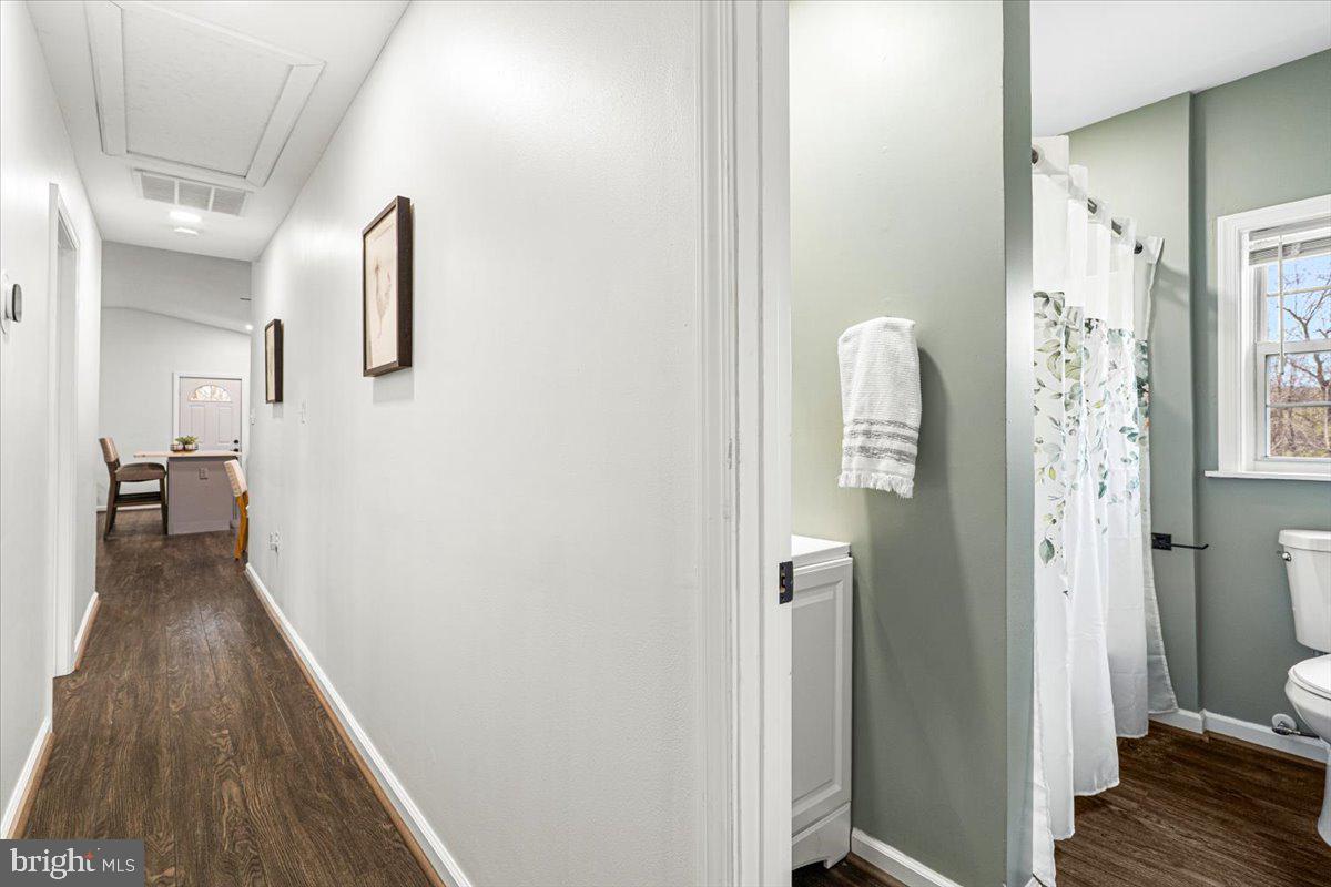 2816 Ballenger Creek Pike Frederick, MD 21703 - Photo 19 of 38 a view of a hallway with wooden floor and a bathroom