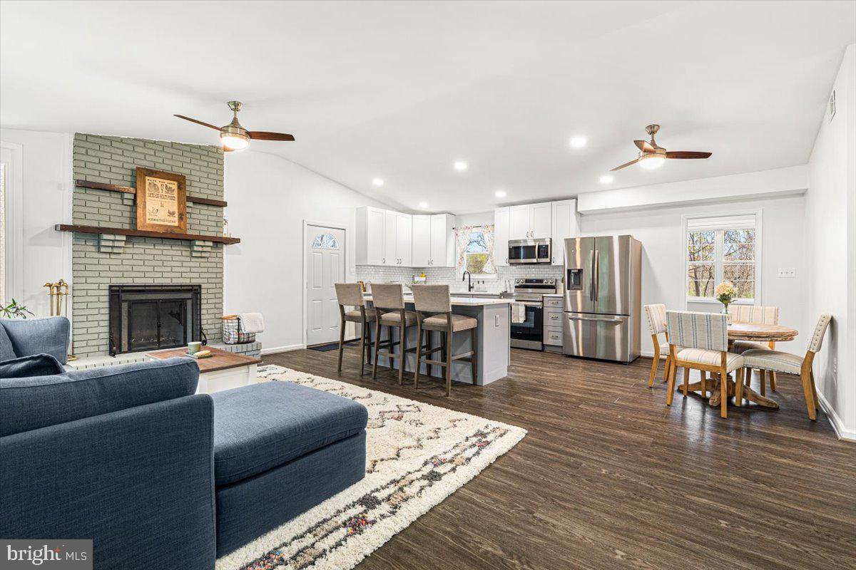 2816 Ballenger Creek Pike Frederick, MD 21703 - Photo 2 of 38 a living room with furniture kitchen view and a fireplace