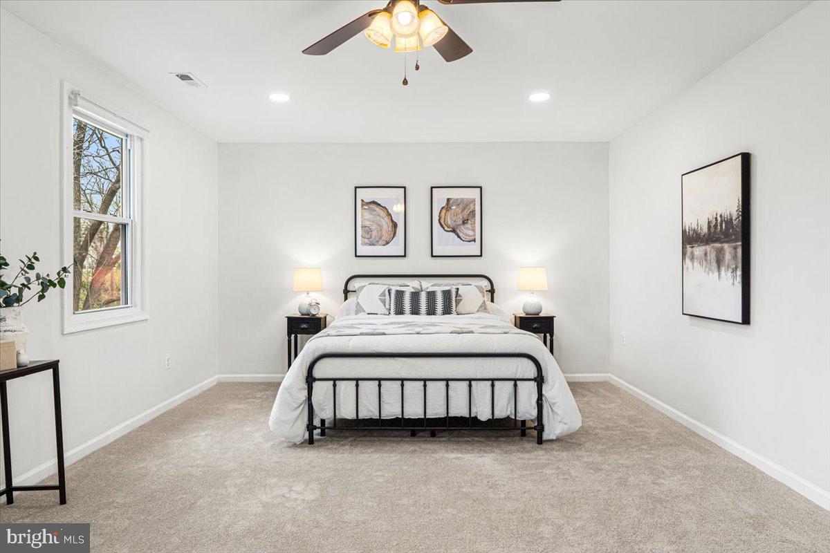 2816 Ballenger Creek Pike Frederick, MD 21703 - Photo 21 of 38 a bedroom with a bed and a painting on the wall