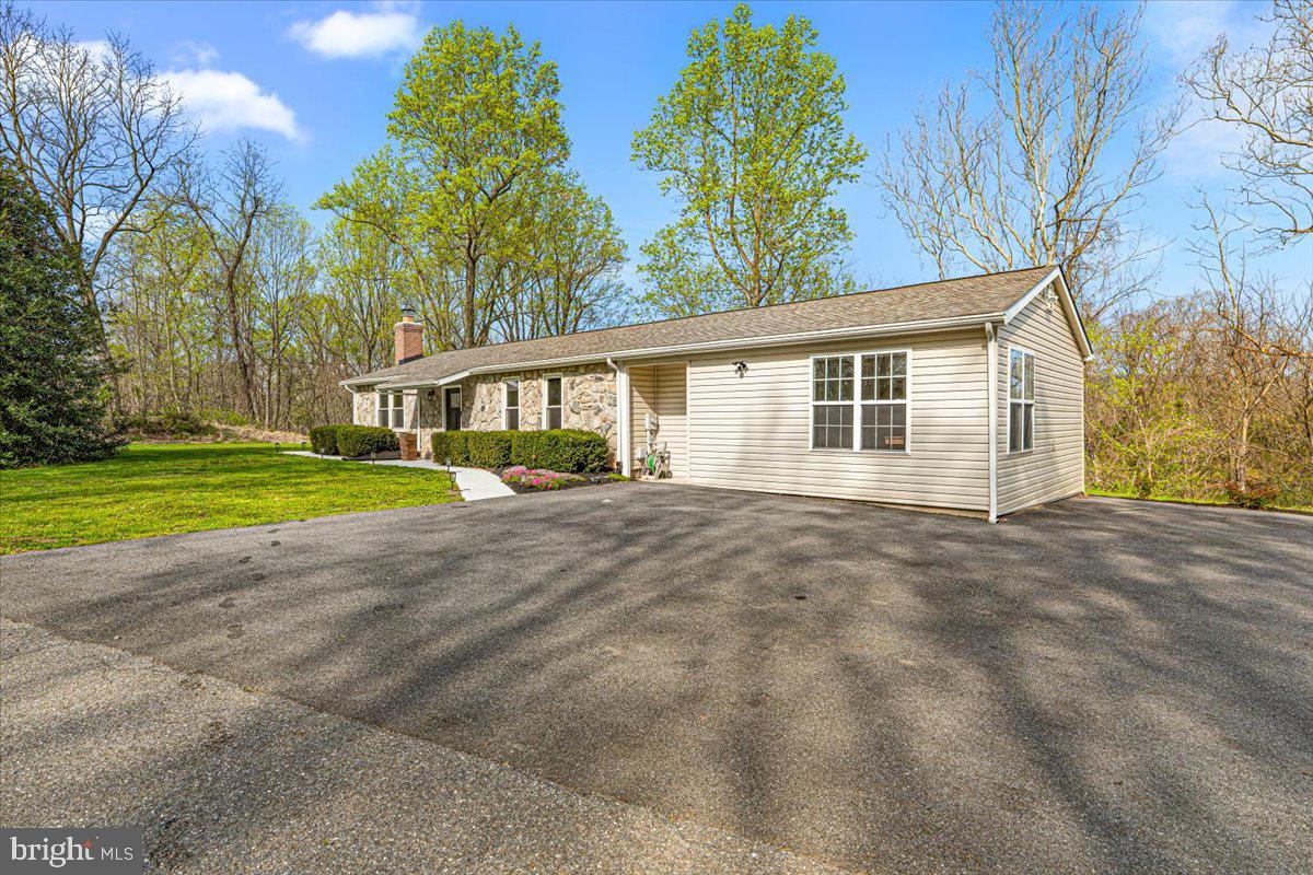 2816 Ballenger Creek Pike Frederick, MD 21703 - Photo 33 of 38 a view of a house with a big yard and large trees