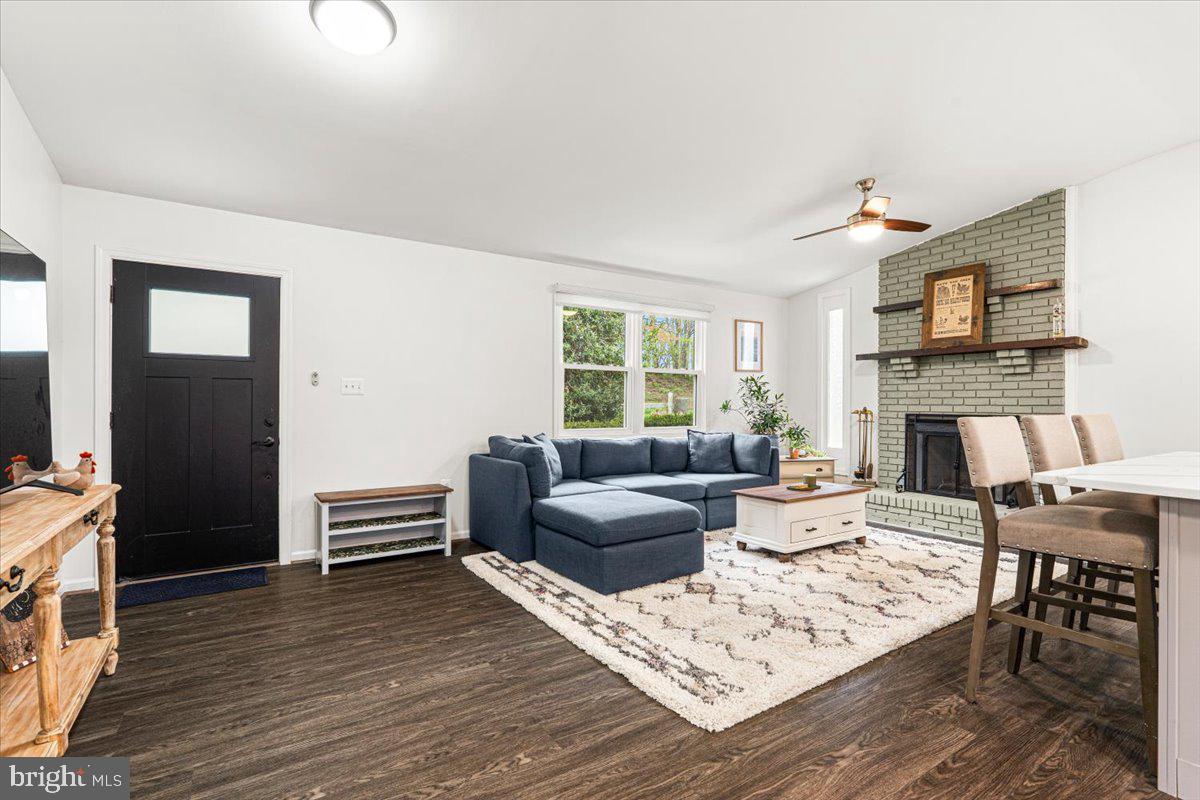 2816 Ballenger Creek Pike Frederick, MD 21703 - Photo 4 of 38 a living room with furniture a fireplace and a flat screen tv