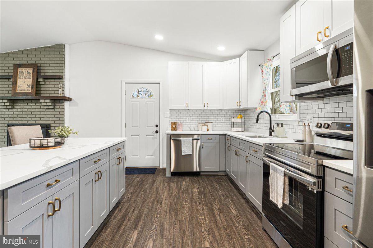2816 Ballenger Creek Pike Frederick, MD 21703 - Photo 8 of 38 a kitchen with stainless steel appliances a sink dishwasher a stove top oven a refrigerator with white cabinets and wooden floor