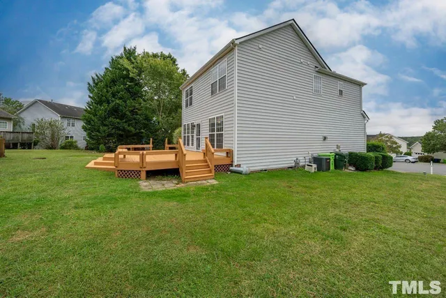 a backyard of a house with table and chairs