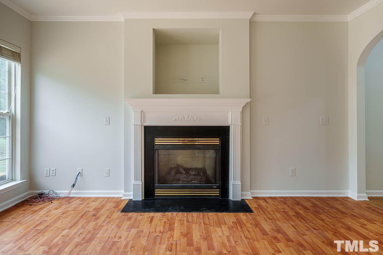 4705 Delta Vision Court, Unit (ID 12461041) Raleigh, NC 27612 - Photo 16 of 35 a view of an empty room with wooden floor fireplace and a window