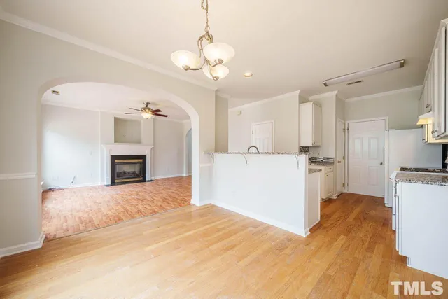 a view of kitchen with sink and refrigerator