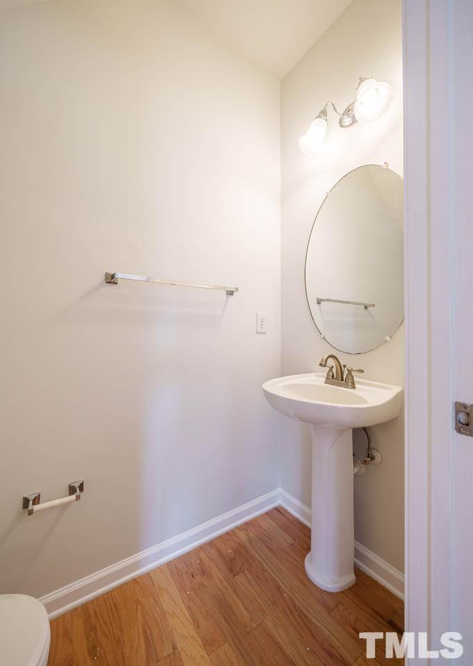 4705 Delta Vision Court, Unit (ID 12461041) Raleigh, NC 27612 - Photo 27 of 35 a bathroom with a sink mirror and toilet