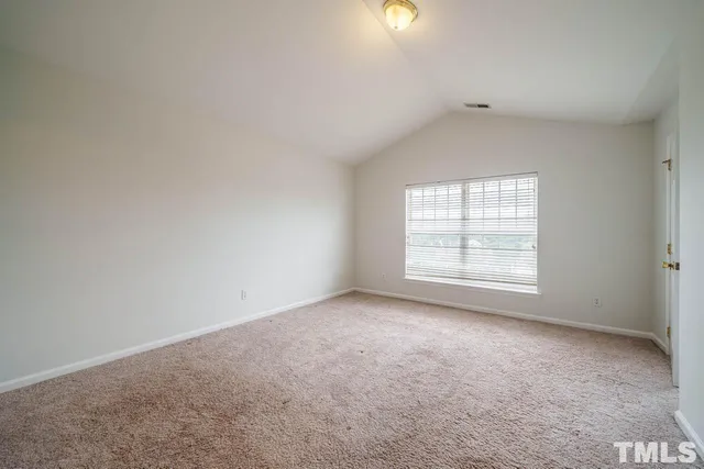 an empty room with a empty space and windows