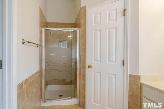 a bathroom with a glass shower door