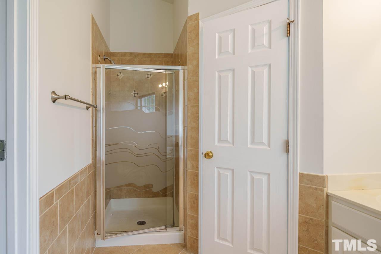 4705 Delta Vision Court, Unit (ID 12461041) Raleigh, NC 27612 - Photo 32 of 35 a bathroom with a glass shower door