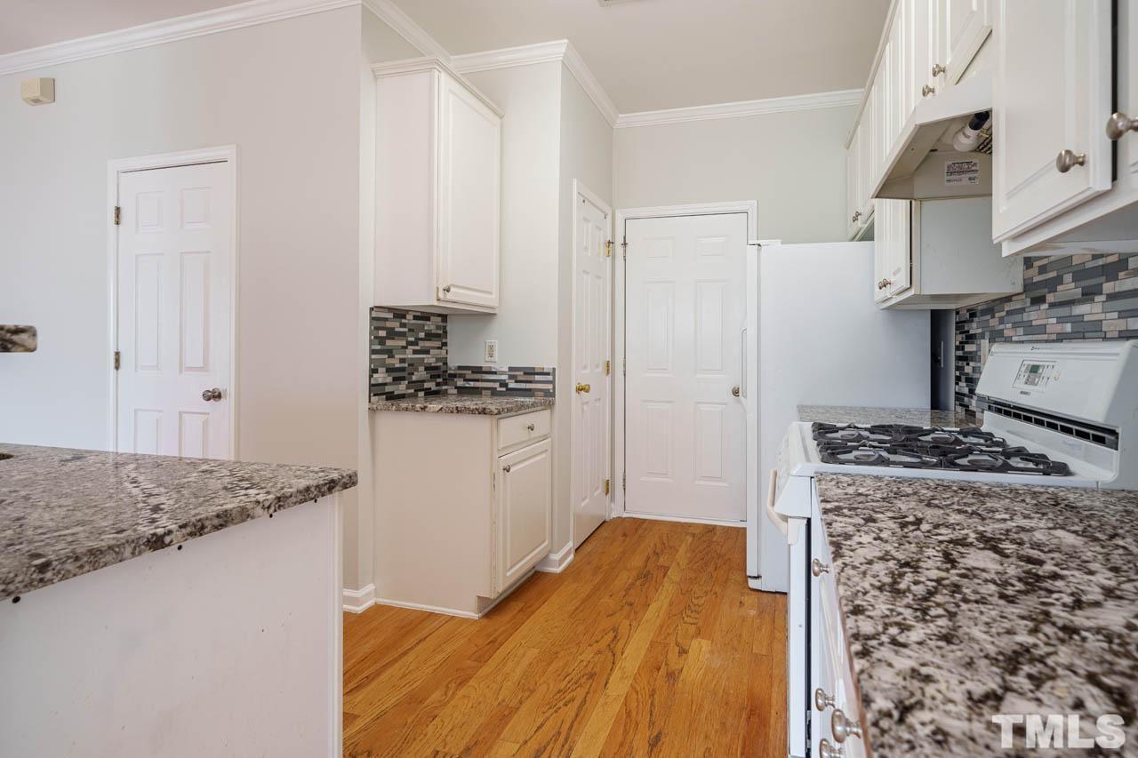4705 Delta Vision Court, Unit (ID 12461041) Raleigh, NC 27612 - Photo 33 of 35 a kitchen with stainless steel appliances granite countertop a stove and a refrigerator