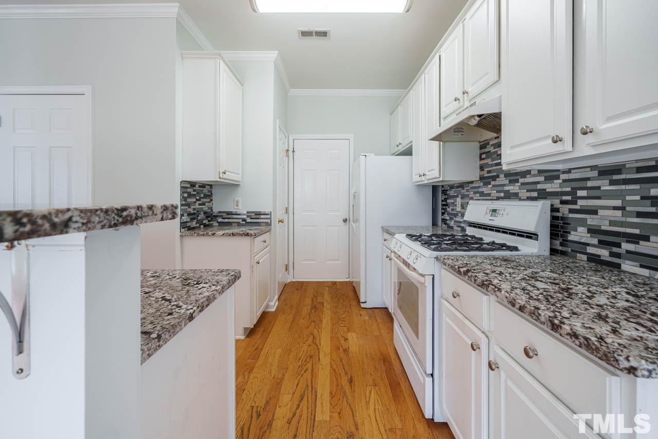 4705 Delta Vision Court, Unit (ID 12461041) Raleigh, NC 27612 - Photo 35 of 35 a kitchen with stainless steel appliances granite countertop a lot of counter space and wooden floor