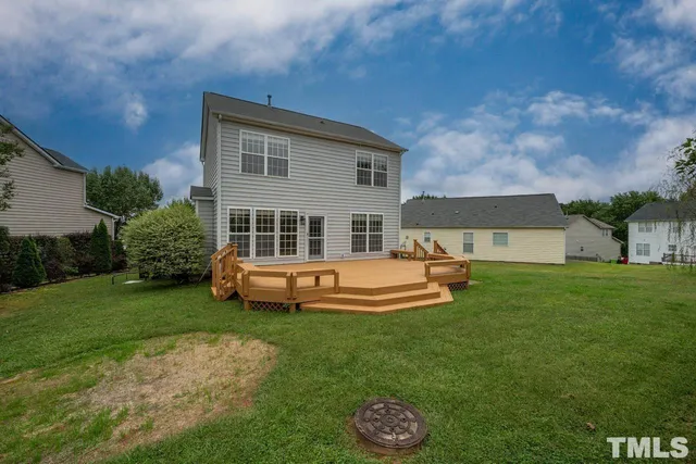 a view of a house with a backyard patio and a garden