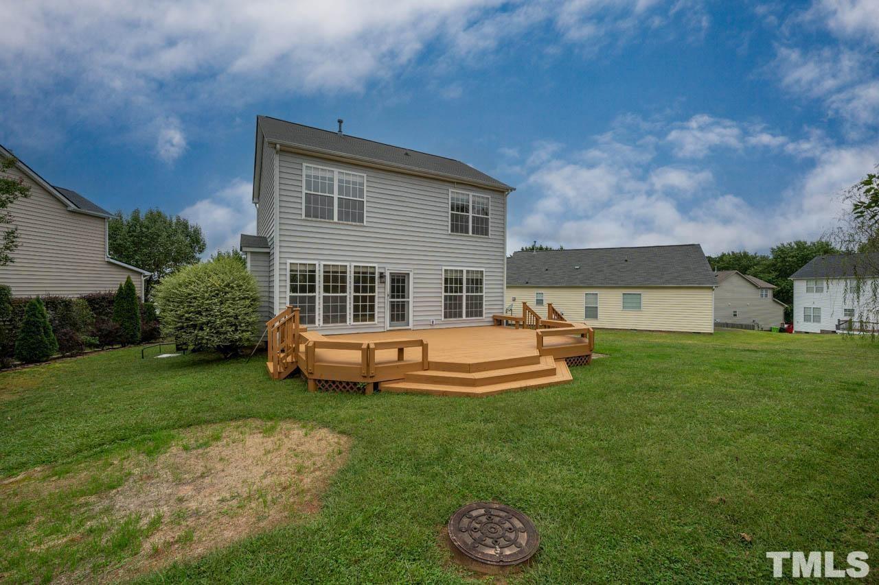 4705 Delta Vision Court, Unit (ID 12461041) Raleigh, NC 27612 - Photo 7 of 35 a view of a house with a backyard patio and a garden