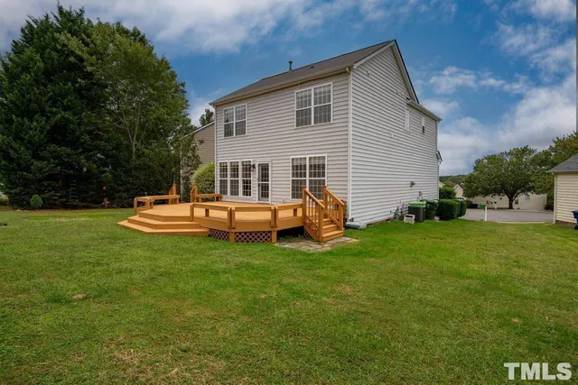 a backyard of a house with table and chairs