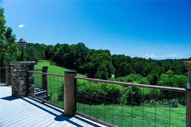 a view of a patio with couches chairs and wooden floor