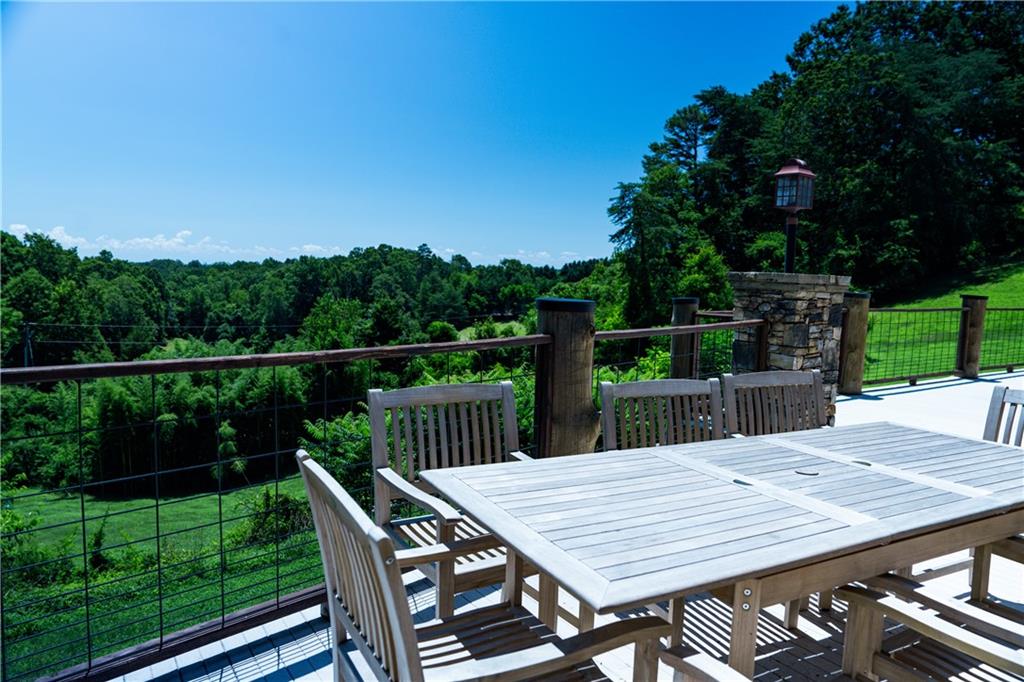 2154 Apple Pie Ridge Road Alto, GA 30510 - Photo 12 of 81 a view of a wooden dinning table and chairs in patio