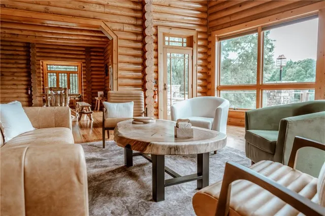 a view of a patio with couches and a dining table and chairs with wooden floor