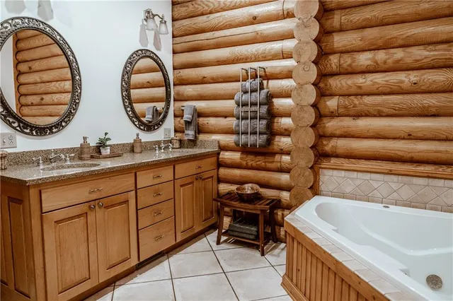 a room with stainless steel appliances kitchen island granite countertop a table chairs in it and wooden floors