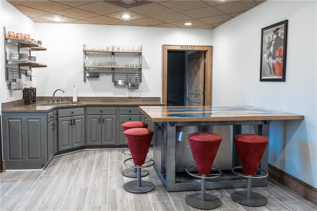 2154 Apple Pie Ridge Road Alto, GA 30510 - Photo 57 of 81 a room with stainless steel appliances kitchen island granite countertop a table chairs in it and wooden floors