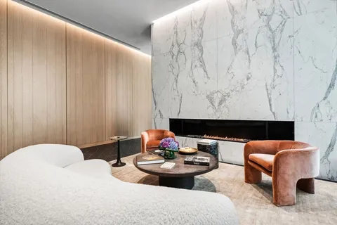 a living room with furniture a flat screen tv and a table