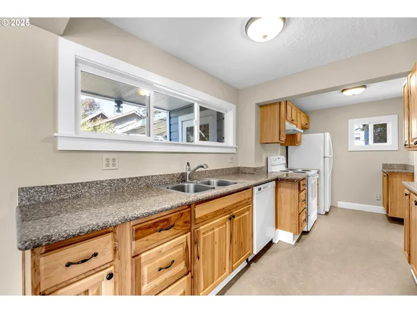 a kitchen with stainless steel appliances granite countertop a sink and dishwasher cabinets with wooden floor