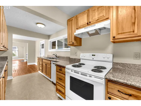 a kitchen with a stove a sink and a refrigerator