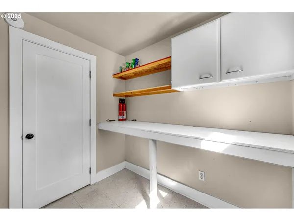 a room with a closet and wooden cabinets