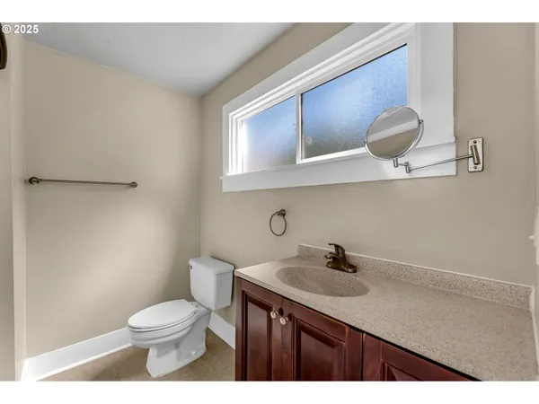 a bathroom with a sink a toilet and mirror