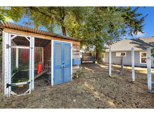 a backyard of a house with barbeque oven fire pit table and chairs