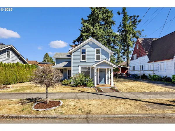 a front view of a house with garden