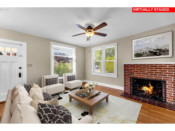 a living room with furniture a fireplace and window