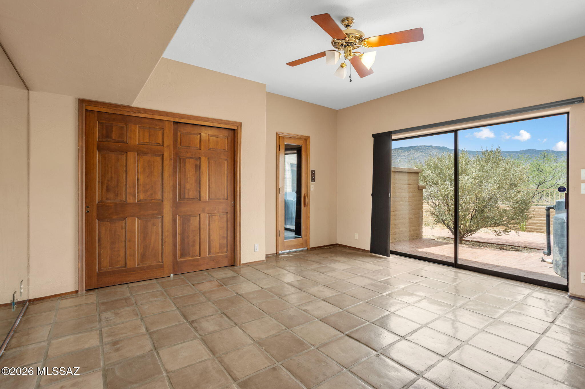 7171 South X9 Ranch Road Vail, AZ 85641 - Photo 40 of 50 Bedroom 5 sliding door to patio. Outdoor rainwater storage tank.