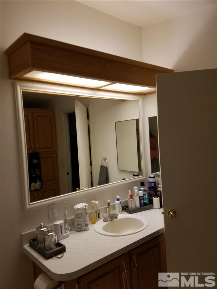 4736 Alcorn Road Fallon, NV 89406 - Photo 6 of 11 a bathroom with a sink and a mirror