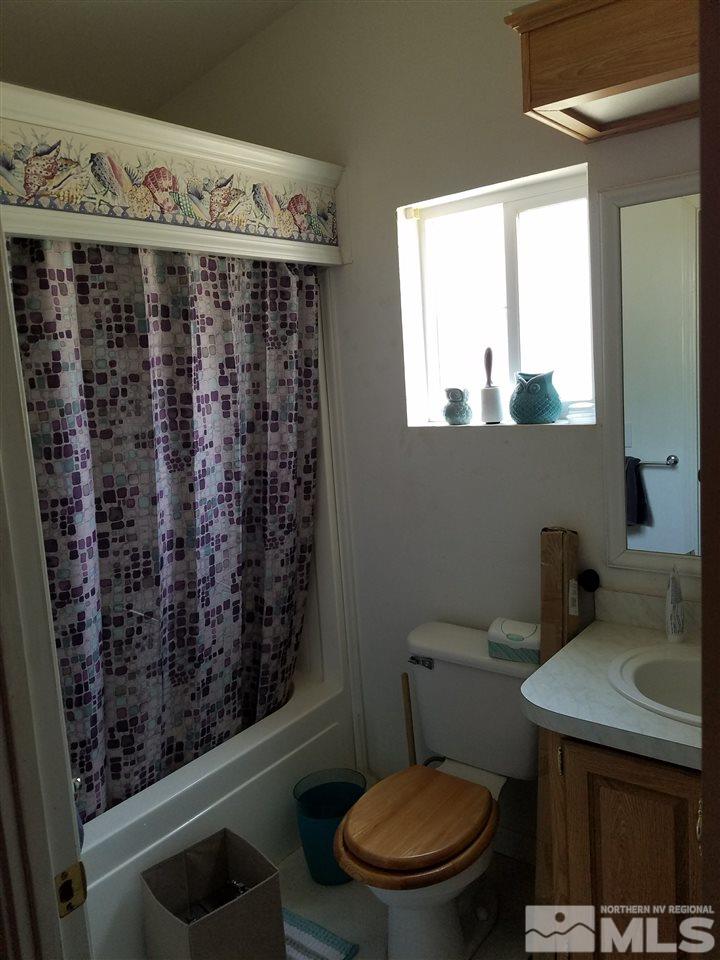 4736 Alcorn Road Fallon, NV 89406 - Photo 8 of 11 a bathroom with a toilet and a sink