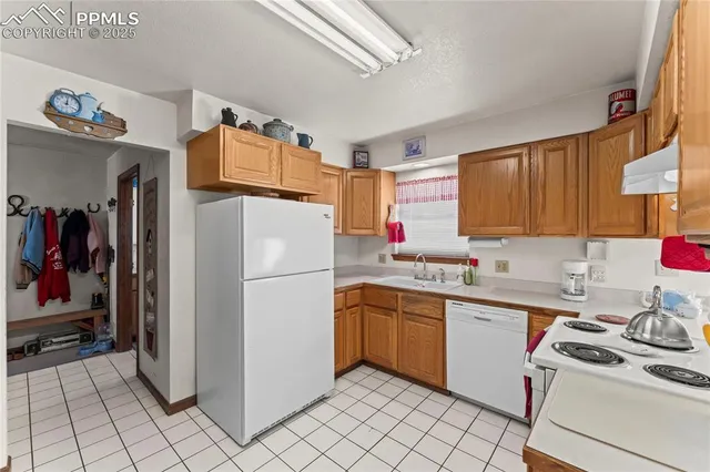 a kitchen with stainless steel appliances granite countertop a stove refrigerator and cabinets