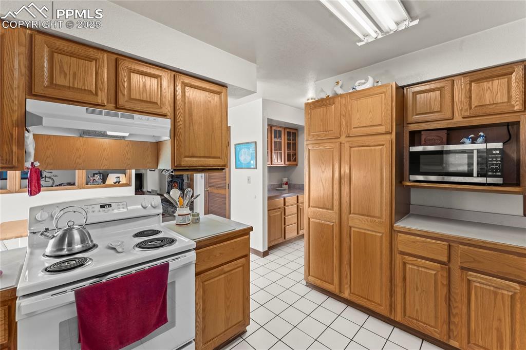 9330 Berridge Road Calhan, CO 80808 - Photo 12 of 50 a kitchen with stainless steel appliances granite countertop a stove refrigerator and cabinets