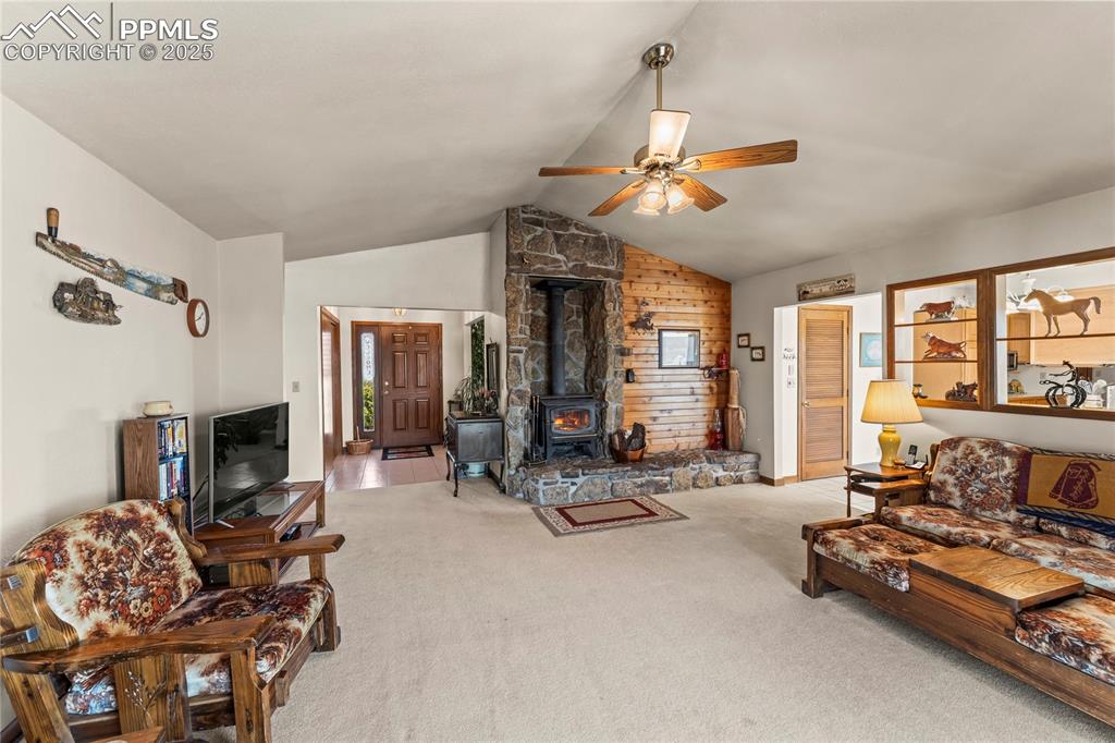 9330 Berridge Road Calhan, CO 80808 - Photo 15 of 50 a living room with furniture gym equipment and a fireplace
