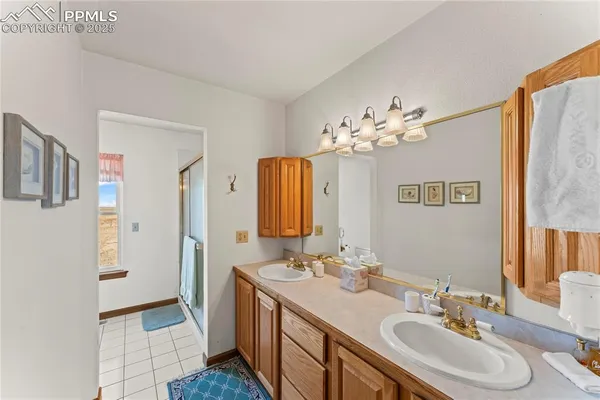 a bathroom with a granite countertop sink mirror vanity and toilet