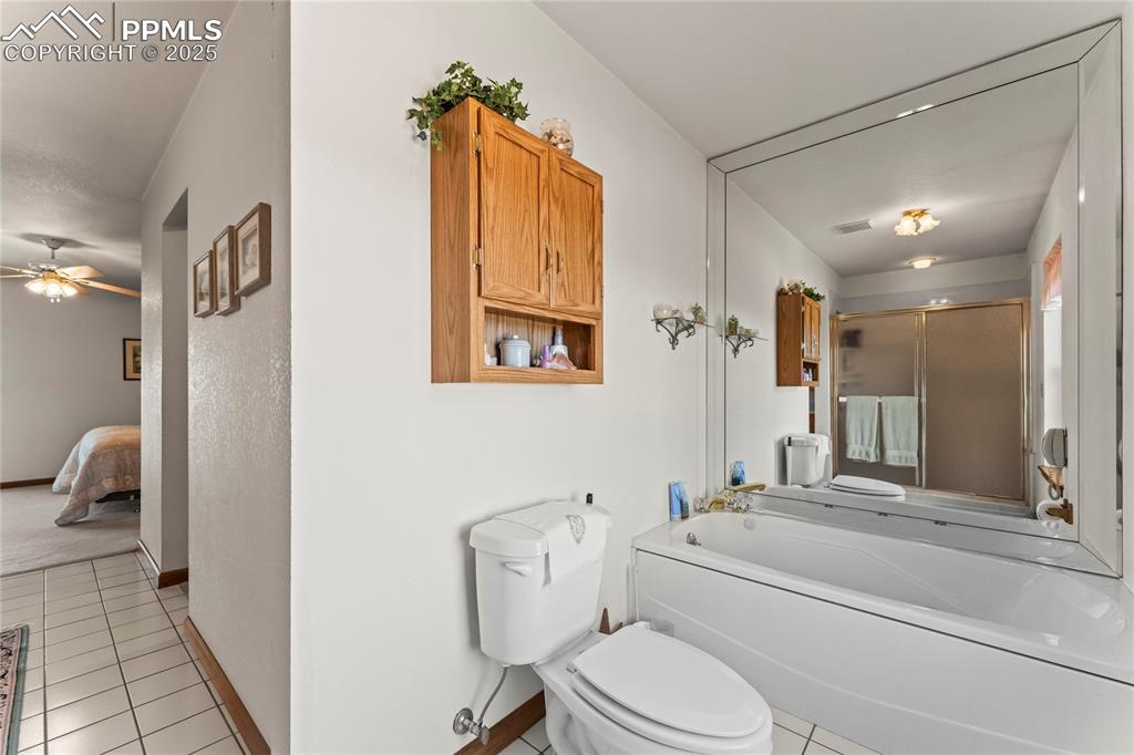 9330 Berridge Road Calhan, CO 80808 - Photo 22 of 50 a bathroom with a granite countertop sink mirror vanity and toilet