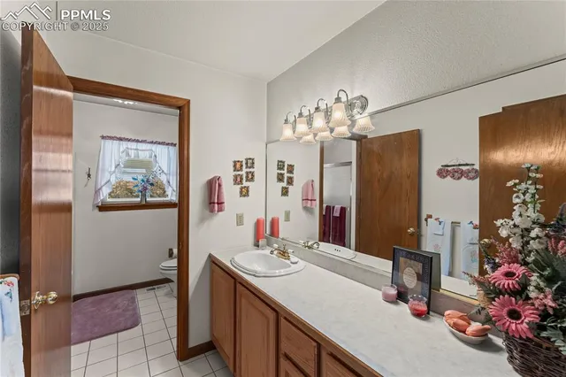 a bathroom with a toilet and a shower curtain