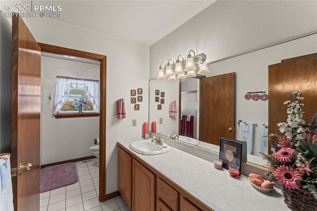 9330 Berridge Road Calhan, CO 80808 - Photo 25 of 50 a bathroom with a sink double vanity and a mirror