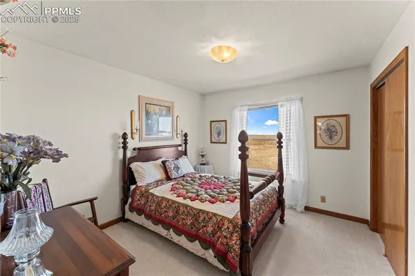 a bedroom with bed and a window