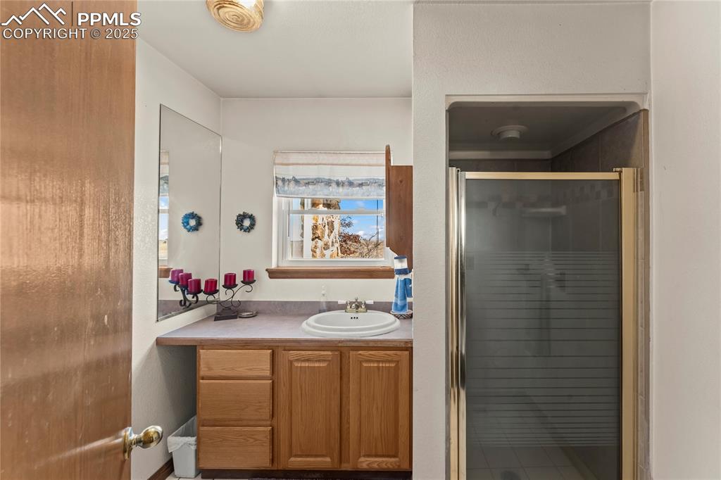 9330 Berridge Road Calhan, CO 80808 - Photo 29 of 50 a bathroom with a sink vanity and a mirror