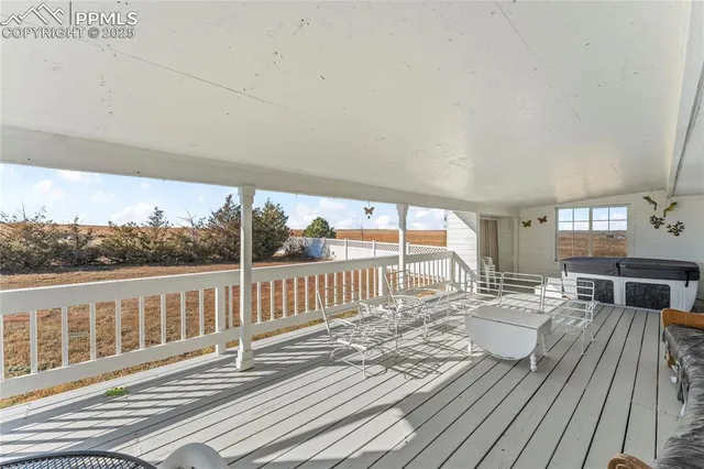 a view of house with a yard and potted plants